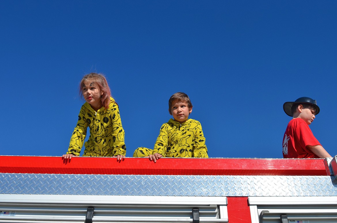 Runa and Oriah Caye and Dalton Plimmer had the best view around of Saturday's Pumpkin Drop at the St. Ignatius Airport. (Kristi Niemeyer/Leader)