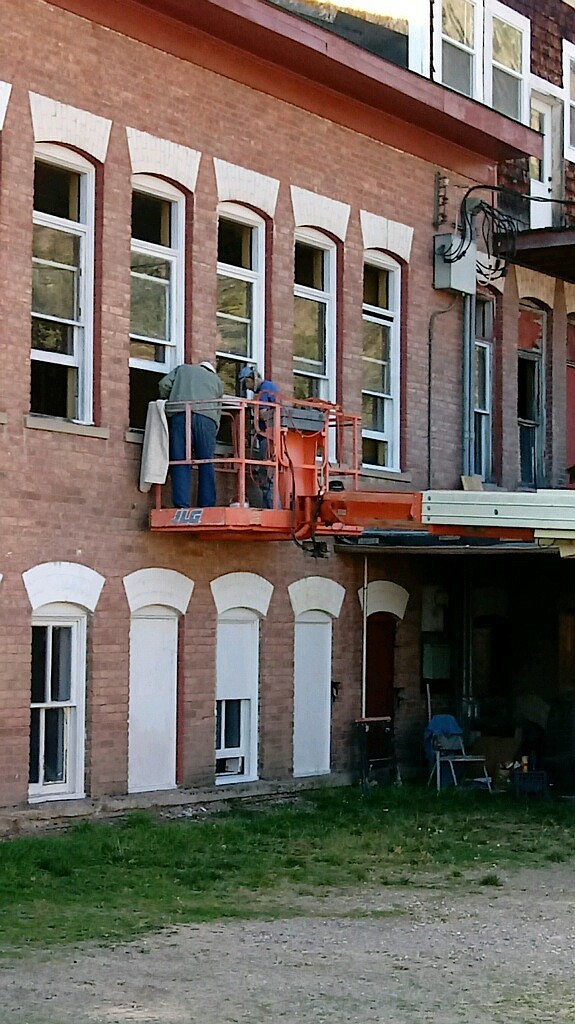 George Gupton uses a lift to work on the Old Superior School. (Photo by Sue Hummel)