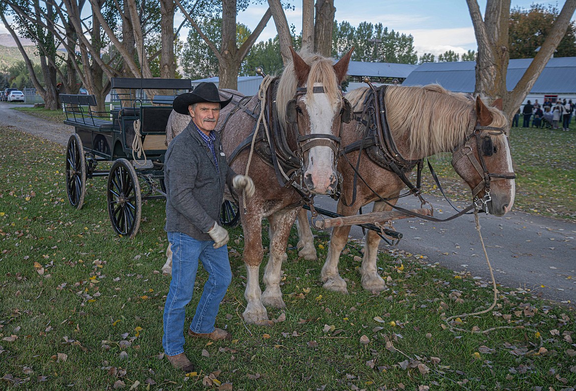 Laurence Walchuck with Belgium draft horses Pete and Ross at Ag Days. (Tracy Scott/Valley Press)