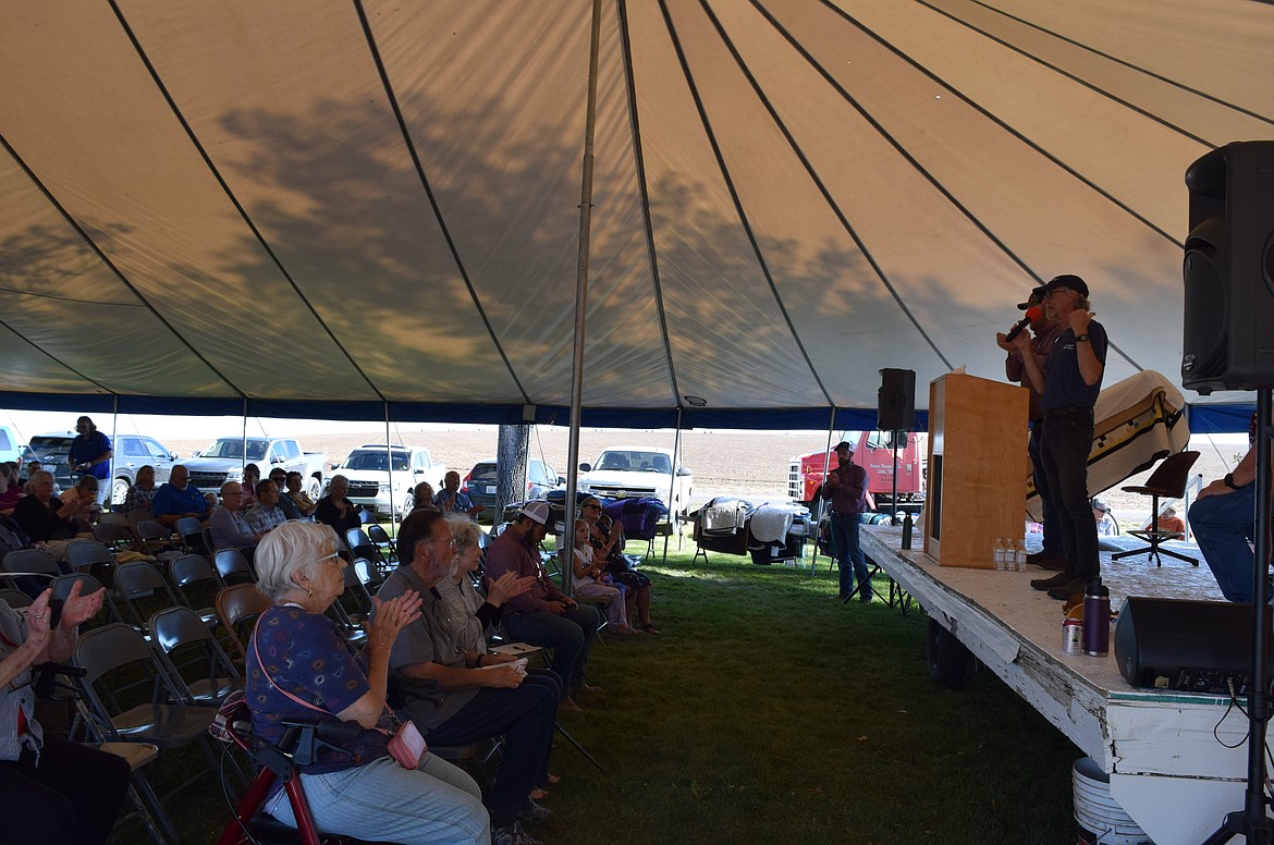 Event organizers introduce the Mennonite Auction Saturday at Menno Mennonite Church outside of Ritzville. The auction traditionally starts with the sale of a loaf of bread that can go for over $1,000.