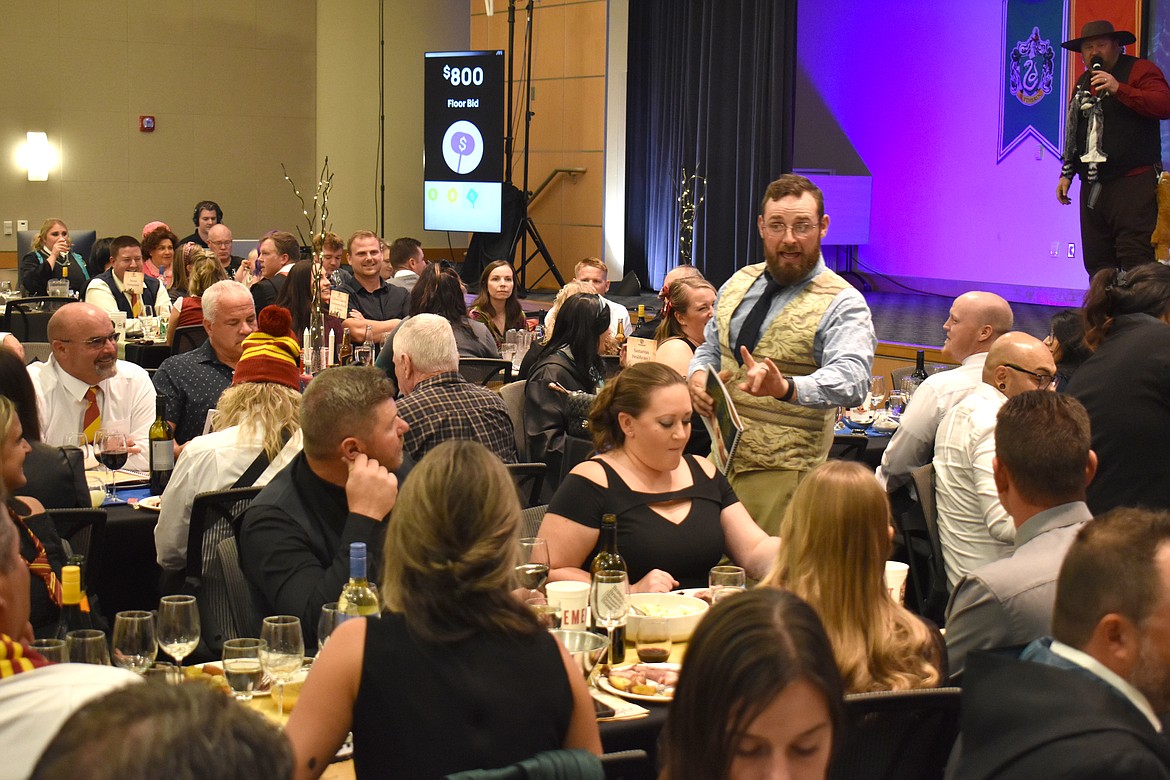 Jacob Barth, with Chuck Yarbro Auctioneers, acknowledges a bid at the Boys & Girls Club auction Saturday.