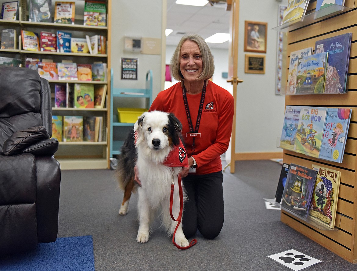 R.E.A.D. volunteer coordinator Susie Gonaver and her dog Andy prepare for the first reader of the day at the Whitefish Community Library. (Julie Engler/Whitefish Pilot)