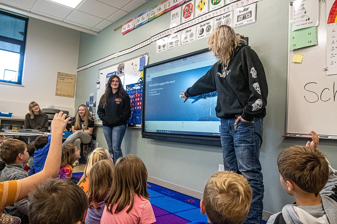 Columbia Falls High Schoolers Emma Snedeker, Samantha Larsen, Holly Lafollet and Chantel Whitcher teach financial literacy to second graders at Glacier Gateway Elementary on Thursday, Oct. 5.
