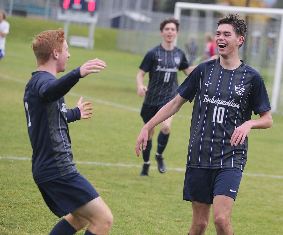 JASON ELLIOTT/Press
Lake City senior midfielder Noah Waddell (10) is congratulated by teammate Gavin Schoener (2) after Waddell's goal in the second half of Wednesday's 5A Region 1 boys soccer championship game.