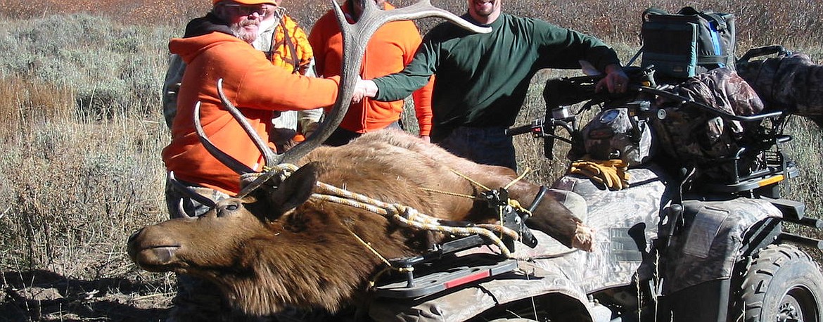 Hunters load a harvested animal onto a motor vehicle. Know the rules for motor vehicles on forest service roads and trails before hunting.