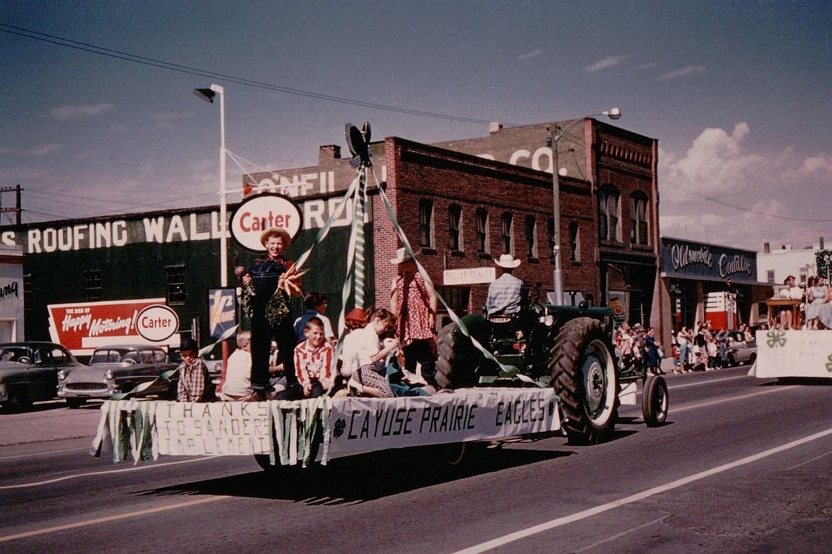 Four-H students ride a float in a parade down Main Street in Kalispell around 1959. Four-H remains a big activity in the Cayuse Prairie community. (Photo provided)