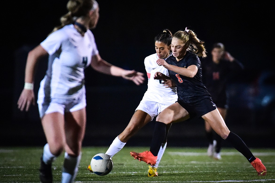 Glacier's Calista Wroble (2) and Flathead's Isla Alexander (8) battle for possession in the first half at Legends Stadium on Thursday, Oct. 12. (Casey Kreider/Daily Inter Lake)