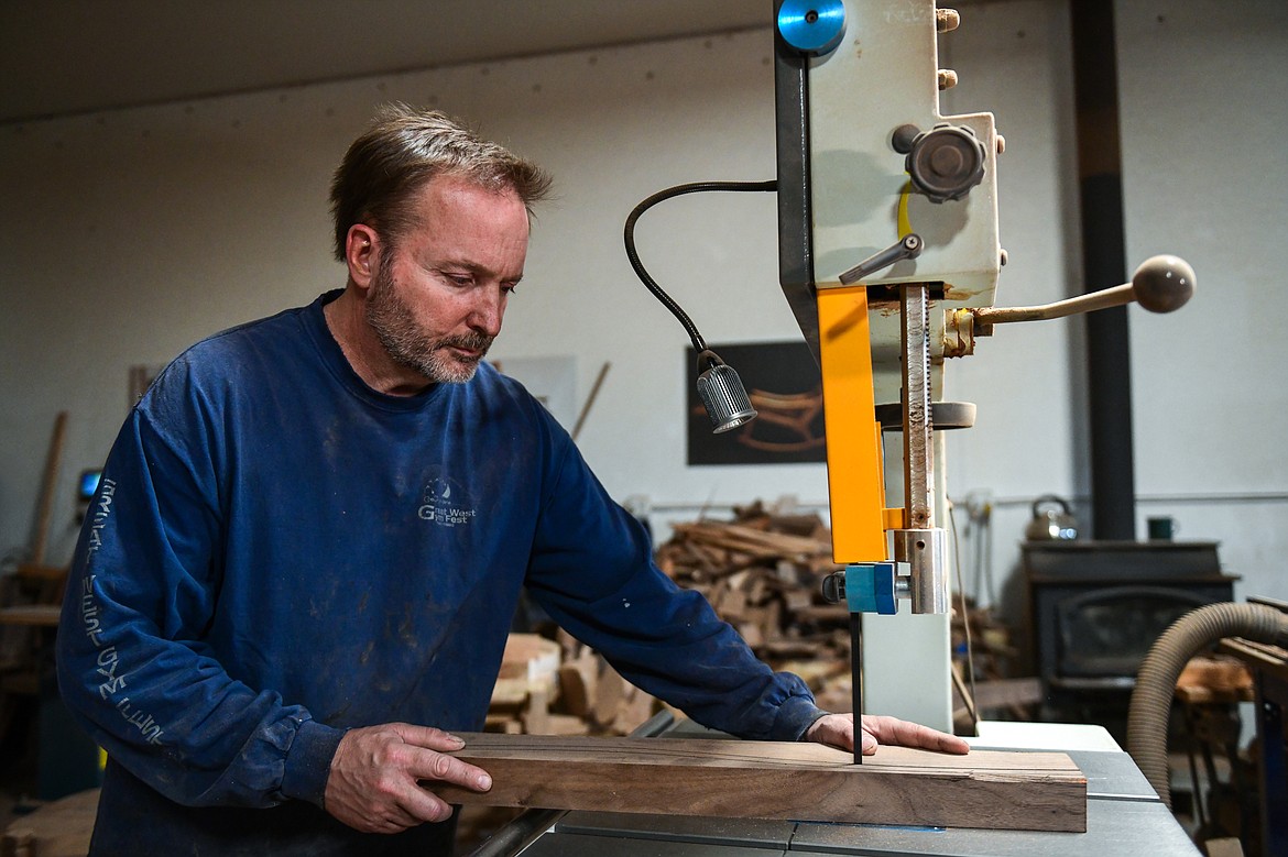 Steve Henneford makes a cut on a band saw for one of his dining chairs at Henneford Fine Furniture on Tuesday, Oct. 10. (Casey Kreider/Daily Inter Lake)