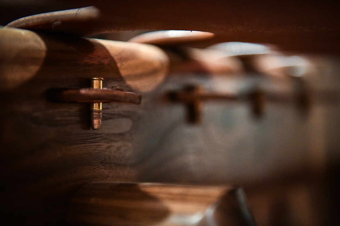 Steve Henneford uses .22 caliber shells to hold the leather seating in place on one of his cowboy rockers at Henneford Fine Furniture on Tuesday, Oct. 10. (Casey Kreider/Daily Inter Lake)