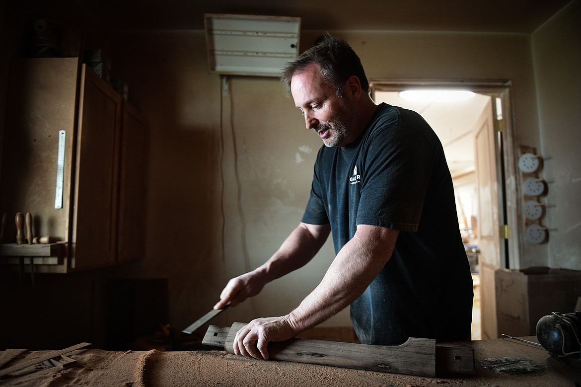 Steve Henneford sands a stretcher for one of his cowboy rockers in the sanding room of his workshop at Henneford Fine Furniture on Tuesday, Oct. 10. (Casey Kreider/Daily Inter Lake)