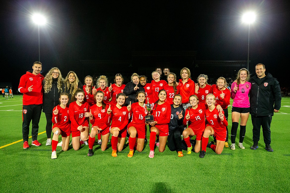 The Sandpoint girls soccer team and coaching staff pose for a photo with the district championship trophy after defeating Moscow, 1-0 at War Memorial Field on Thursday.