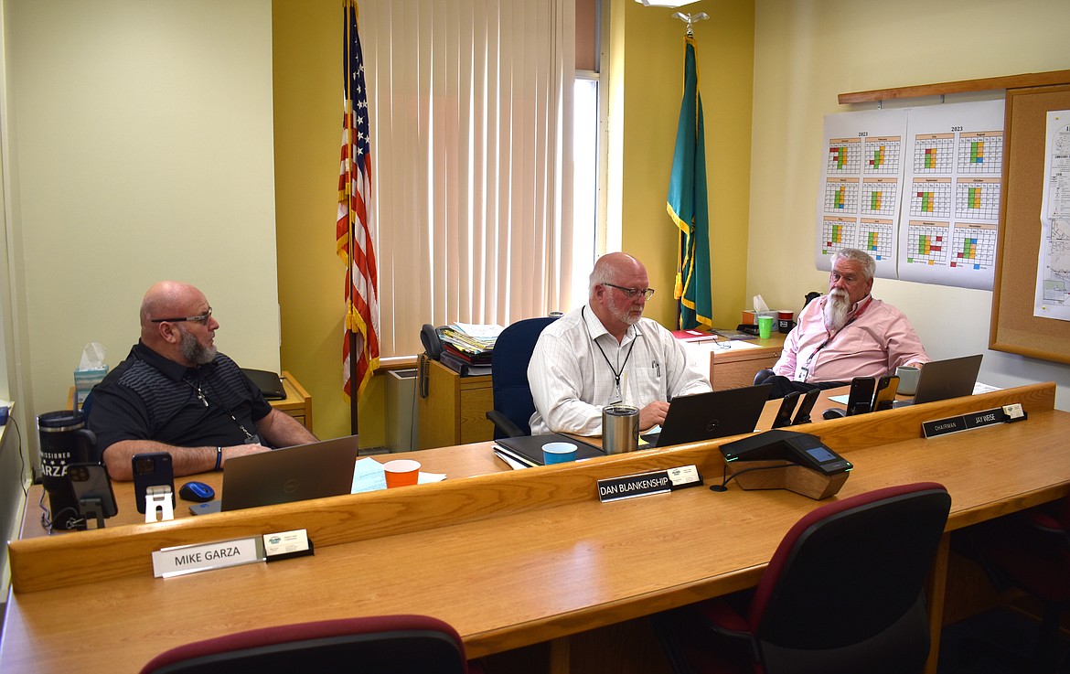 From left: Adams County Commissioners Mike Garza, Dan Blankenship and Jay R. Weise meet at the Adams County Courthouse in May. The commissioners were updated Tuesday on the county’s financial position.