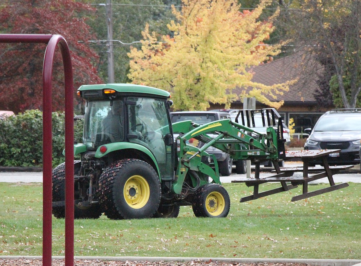 A tractor removes a picnic table from Travers Park Wednesday to prepare for renovations.