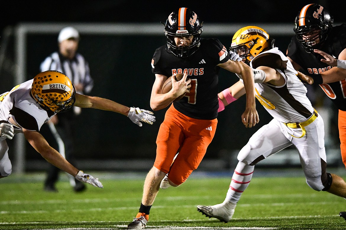 Flathead quarterback Brett Pesola (4) picks up yardage on a run in the second quarter against Helena Capital at Legends Stadium on Friday, Oct. 13. (Casey Kreider/Daily Inter Lake)