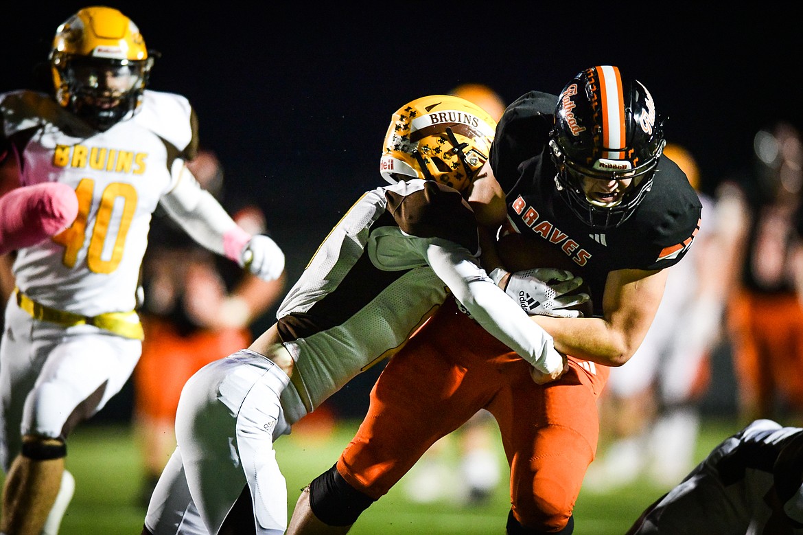 Flathead tight end Gabe Sims (84) is tackled by Helena Capital defensive back Ryan Martinie (11) after a reception in the fourth quarter at Legends Stadium on Friday, Oct. 13. (Casey Kreider/Daily Inter Lake)