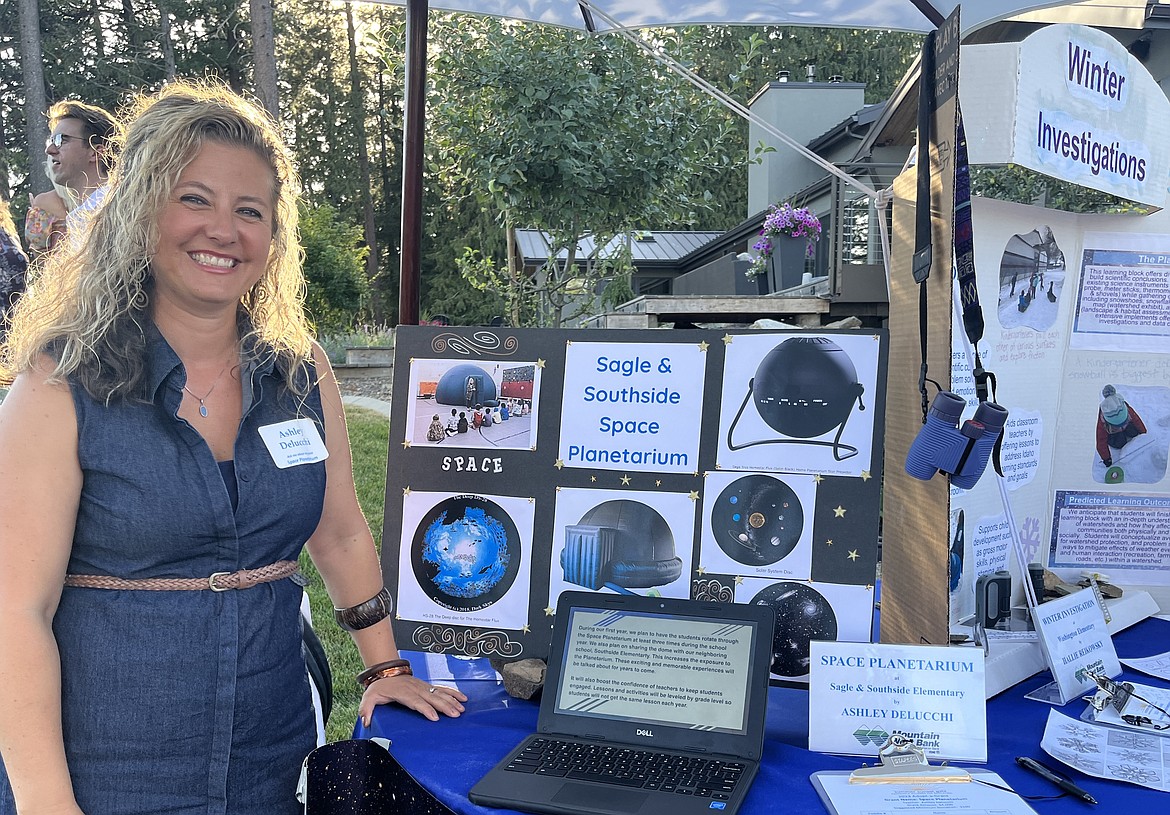 Sagle Elementary teacher Ashley Delucchi is pictured at a Panhandle Alliance for Education event by a display showcasing the new planetarium funded through a grant received from the organization.