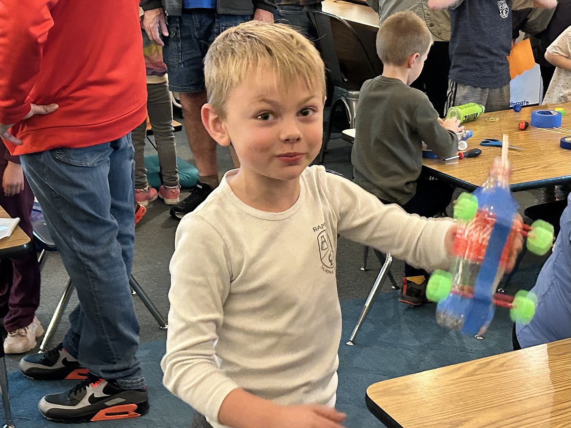 Kayden Mills Drader shows off his balloon-powered car Thursday during a STEM night at Ramsey Magnet School of Science.