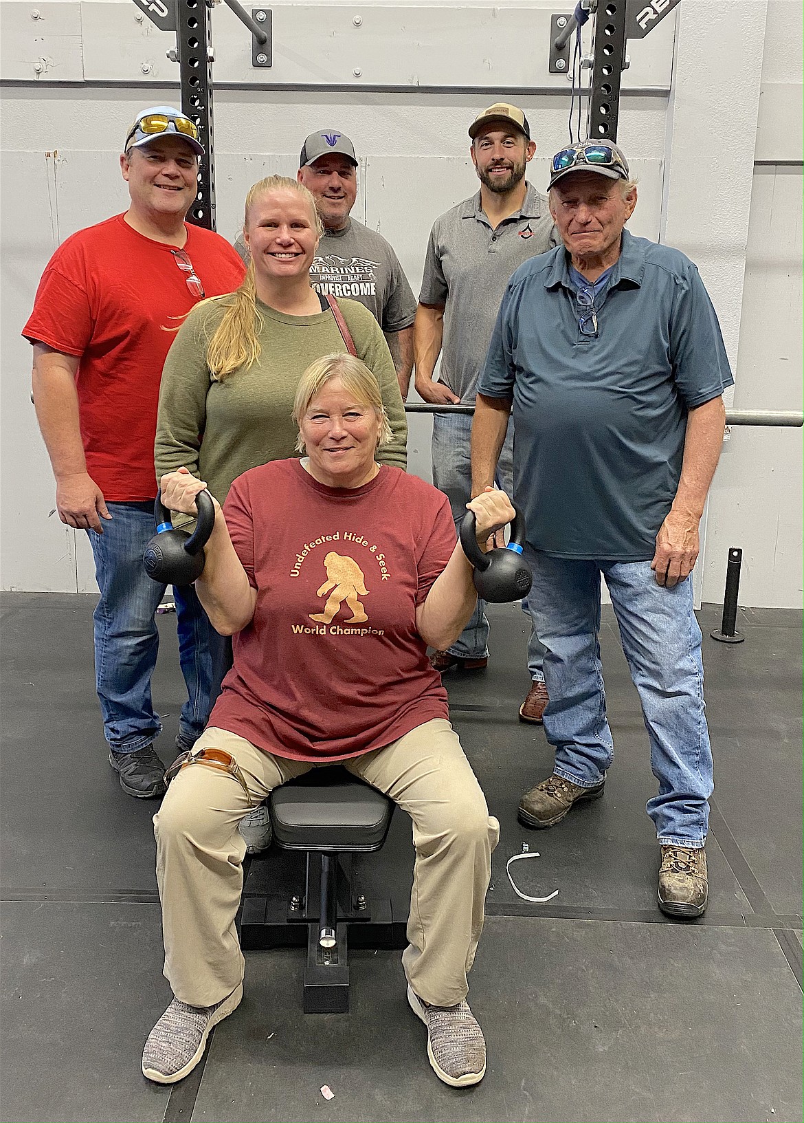 Susie Thoft pumps iron in Charlo School's new weight room, while Gregg Plimmer, Stacey Thoft-Plimmer, Jake Sharbono, Brandon Rollins, and Bob Thoft look on. Also instrumental in getting the project completed were Blaine Cox, Josh Volinkaty, Jared Doty, Stan Atchley and Reese Cox. (Photo provided)