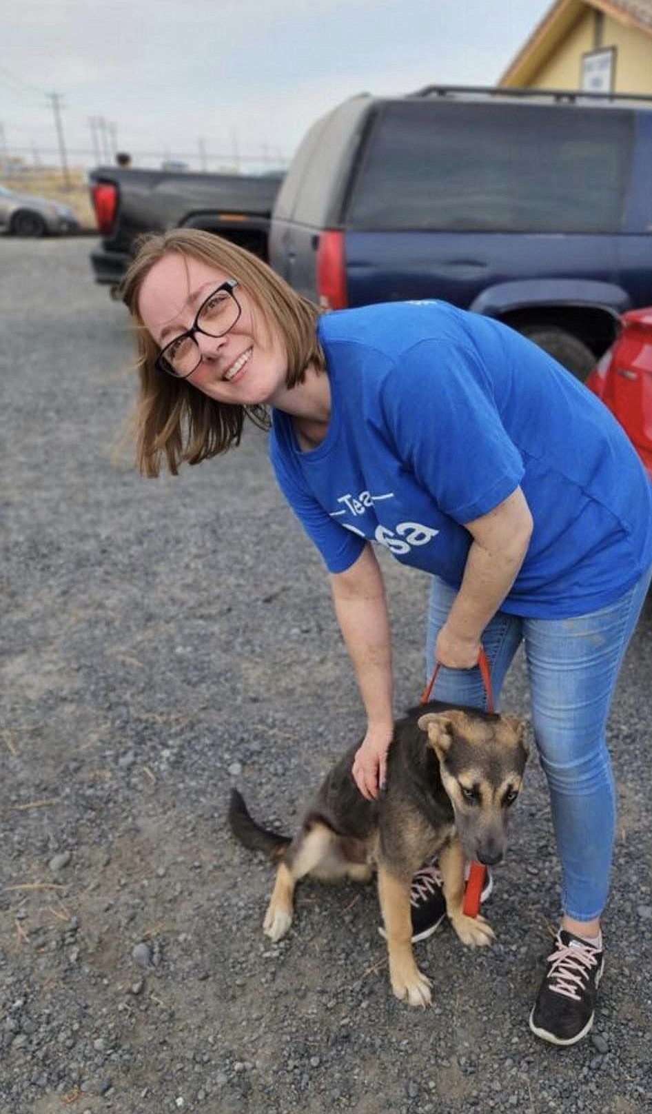 A volunteer walks a dog during Gesa Credit Union's day of service at Grant County Animal outreach.