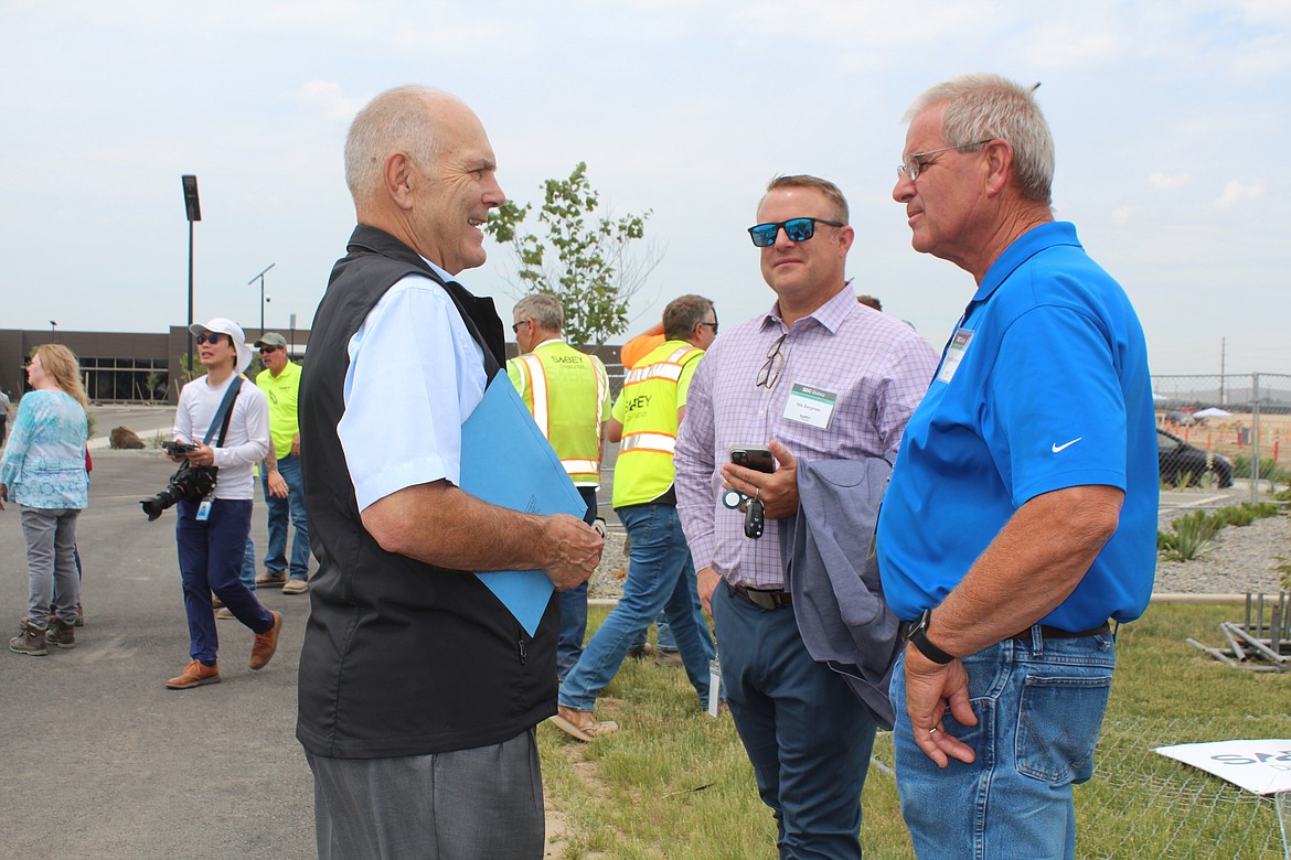 Sabey Data Centers founder Dave Sabey, left, talks to Grant County PUD Commissioner Larry Schaapman, right, and Quincy School District Superintendent Nik Bergman, center, during a ceremony marking expansion of the company’s Quincy facility in June 2023.