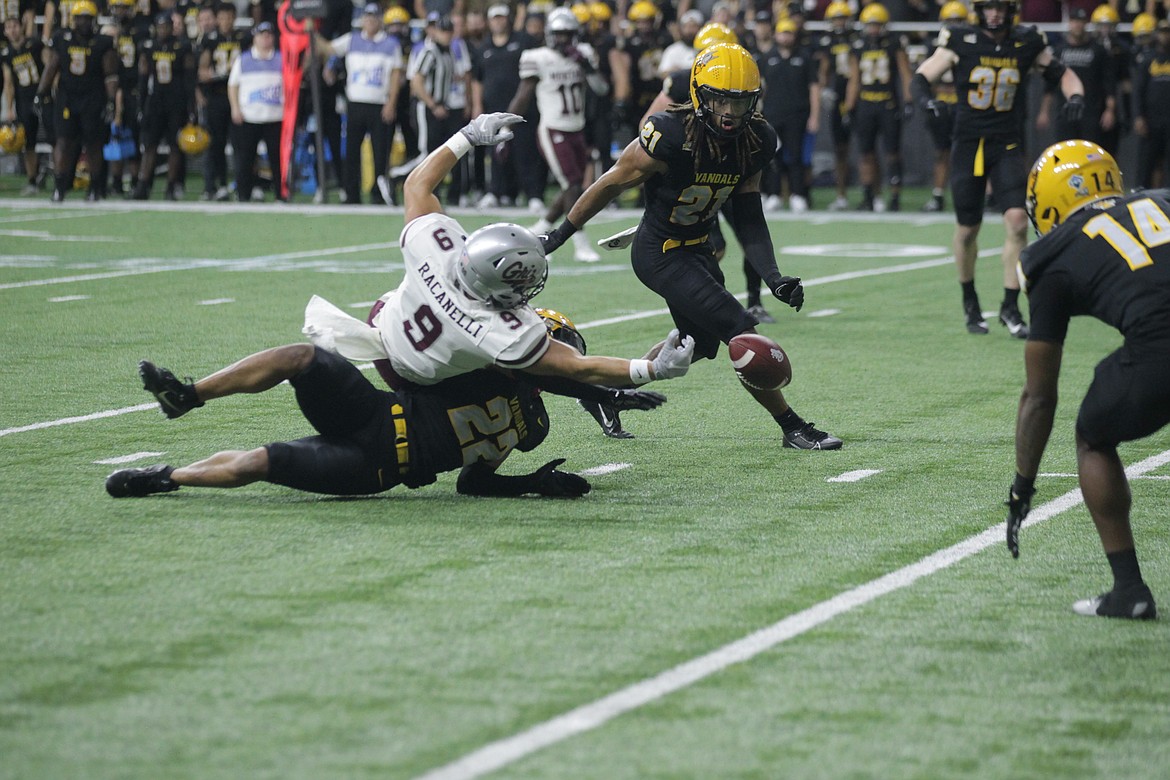 MARK NELKE/Press
Sawyer Racanelli (9) of Montana reaches for a pass, along with Dwayne McDougle (22) and Tre Thomas (21) of Idaho in the first half Saturday in Moscow.