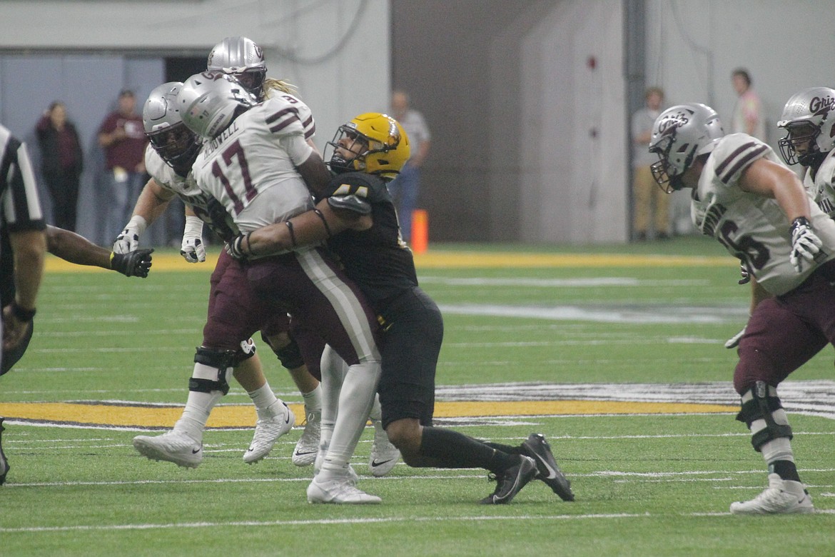 MARK NELKE/Press
Keyshawn James-Newby of Idaho sacks Montana quarterback Clifton McDowell in the second half Saturday night in Moscow.