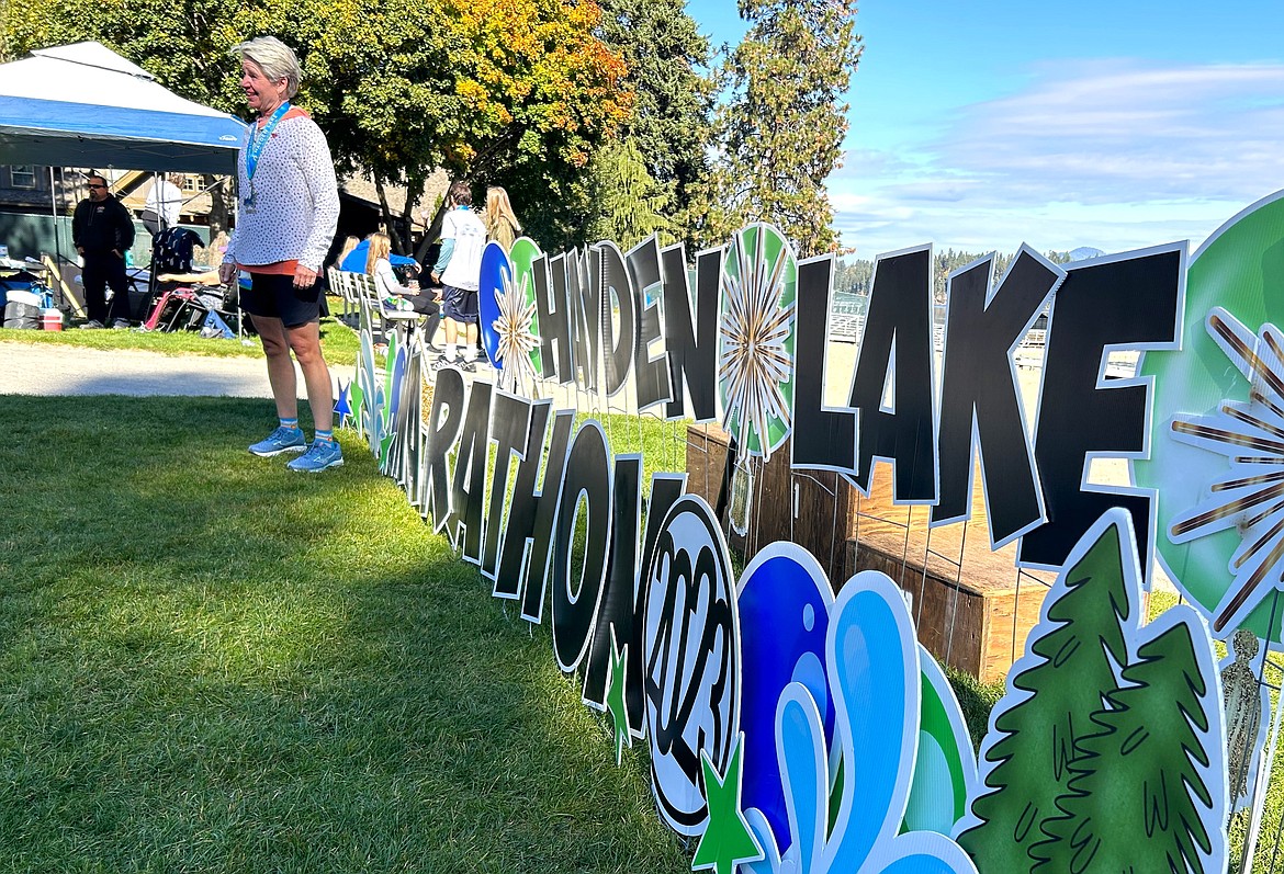 Kristine Nunn poses for photos after finishing the Hayden Lake Marathon on Saturday.