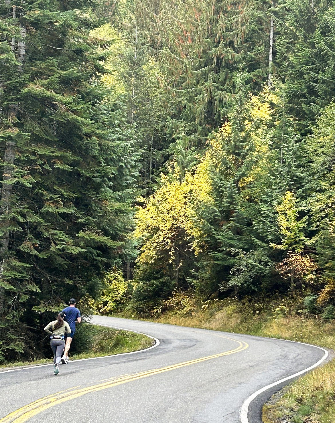 Sam Bice of Coeur d'Alene and Paige Abel of Idaho Falls climb a hill early in the Hayden Lake Marathon on Saturday.