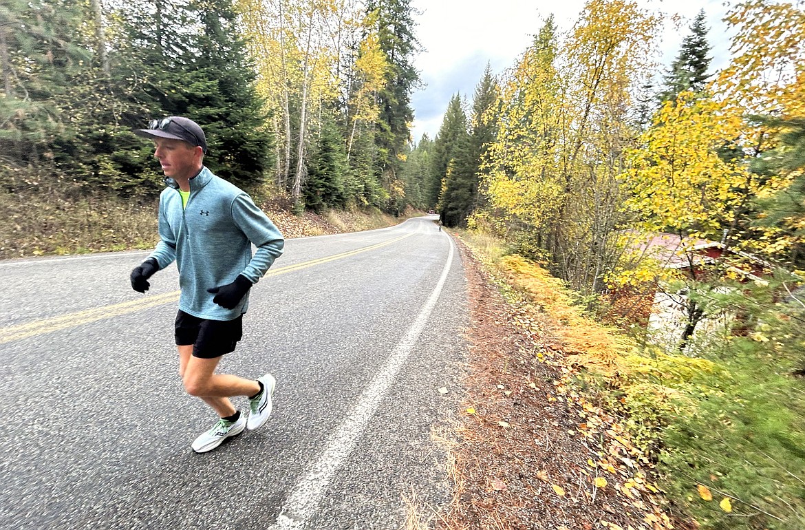 Dustin Poe of Post Falls makes his way up a hill in the Hayden Lake Marathon on Saturday.