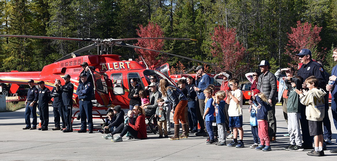 Officers and families enjoy watching the Northwest Montana Regional SWAT's bite demonstration at the Emergency Services Center open house last weekend. (Julie Engler/Whitefish Pilot)