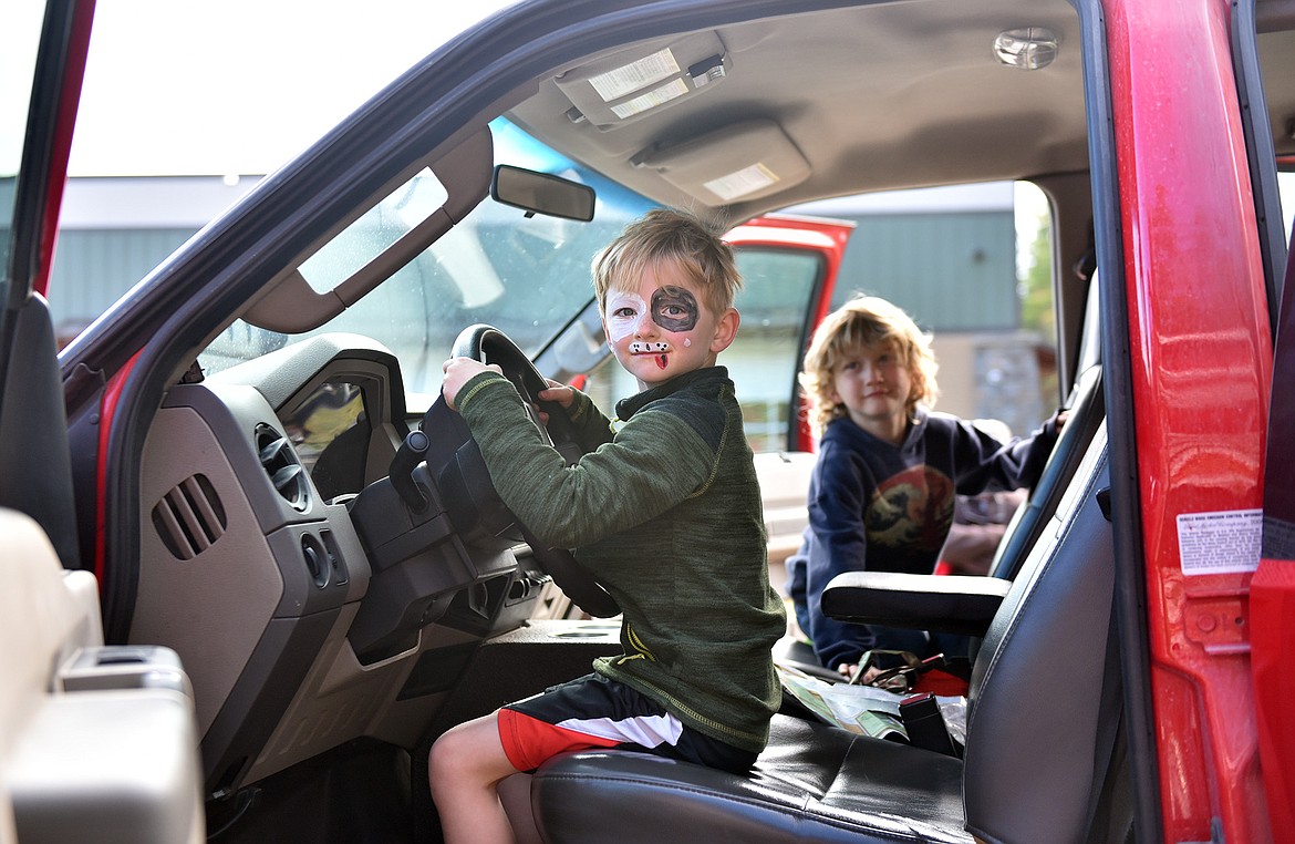 Seven-year-old Andrew Saeger takes a turn behind the wheel of a fire truck during the open house at the Emergency Services Center. (Julie Engler/Whitefish Pilot)