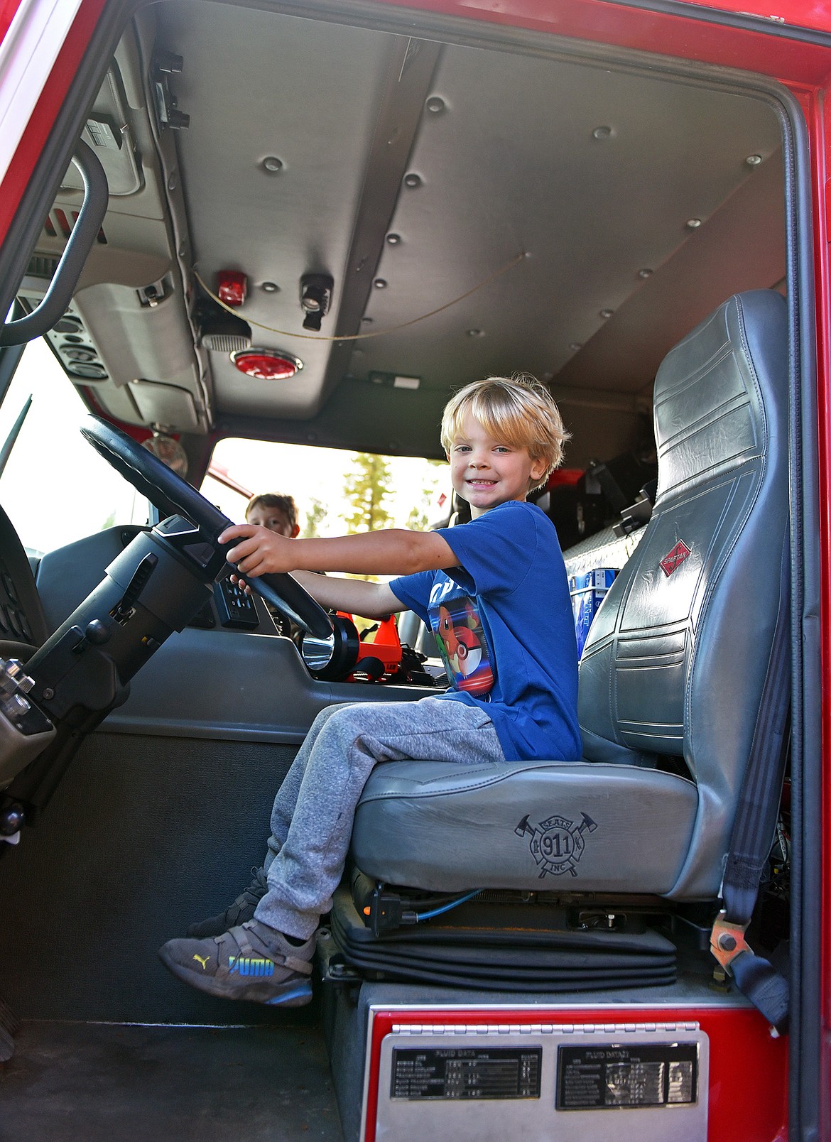 Six-year-old Sam Garver got behind of the wheel of a fire truck at the Emergency Services Center's open house. (Julie Engler/Whitefish Pilot)