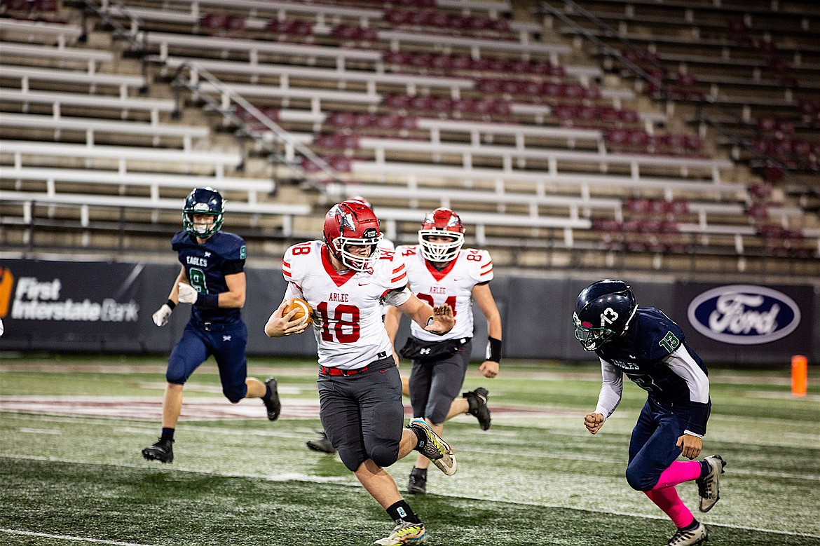 Warrior Jake Knoll fends off an Eagle during the Arlee's conference game against Valley Christian. Knoll scored four touchdowns and rushed for 292 yards for his team during the hard-fought matchup Oct. 13 at Washington-Grizzly Stadium. (Jamie Reil photo)