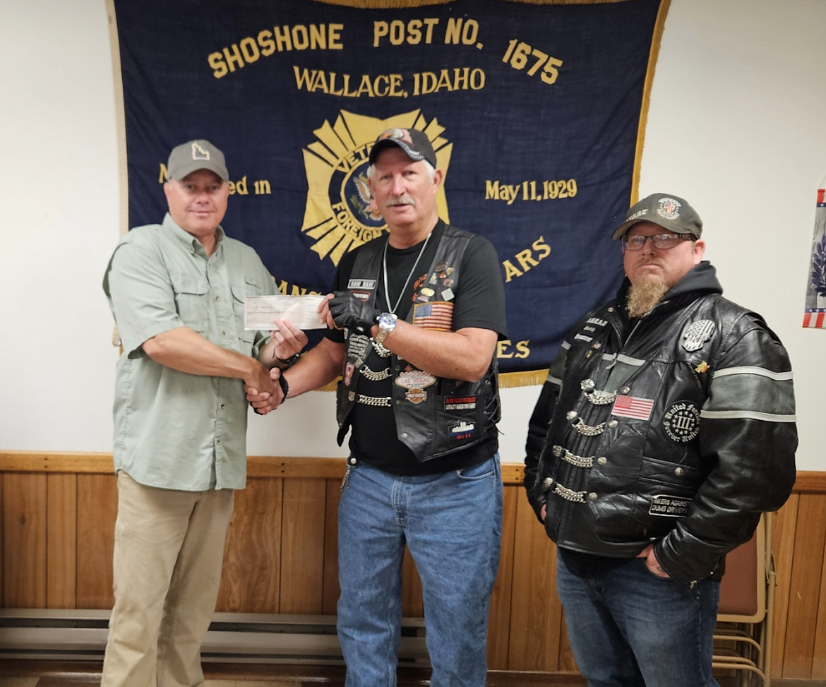 Chris Marker (left) accepts a check for $2,700 from Don Byrd on behalf of the local VFW chapter. Byrd organizes the the Serving our Military Mountain Ride & Rally, a motorcycle ride that spans the length of Shoshone County raising money for organizations that support veteran services.