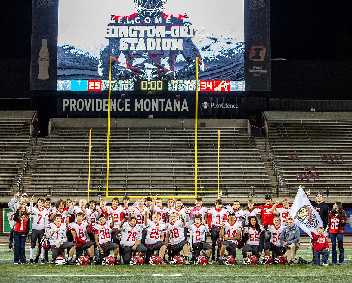 The Arlee Warriors celebrate on Griz turf after winning the Western eight-man championship Saturday at Washington-Grizzly Stadium, where they bested Valley Christian 34-25. (Jamie Reil photo)