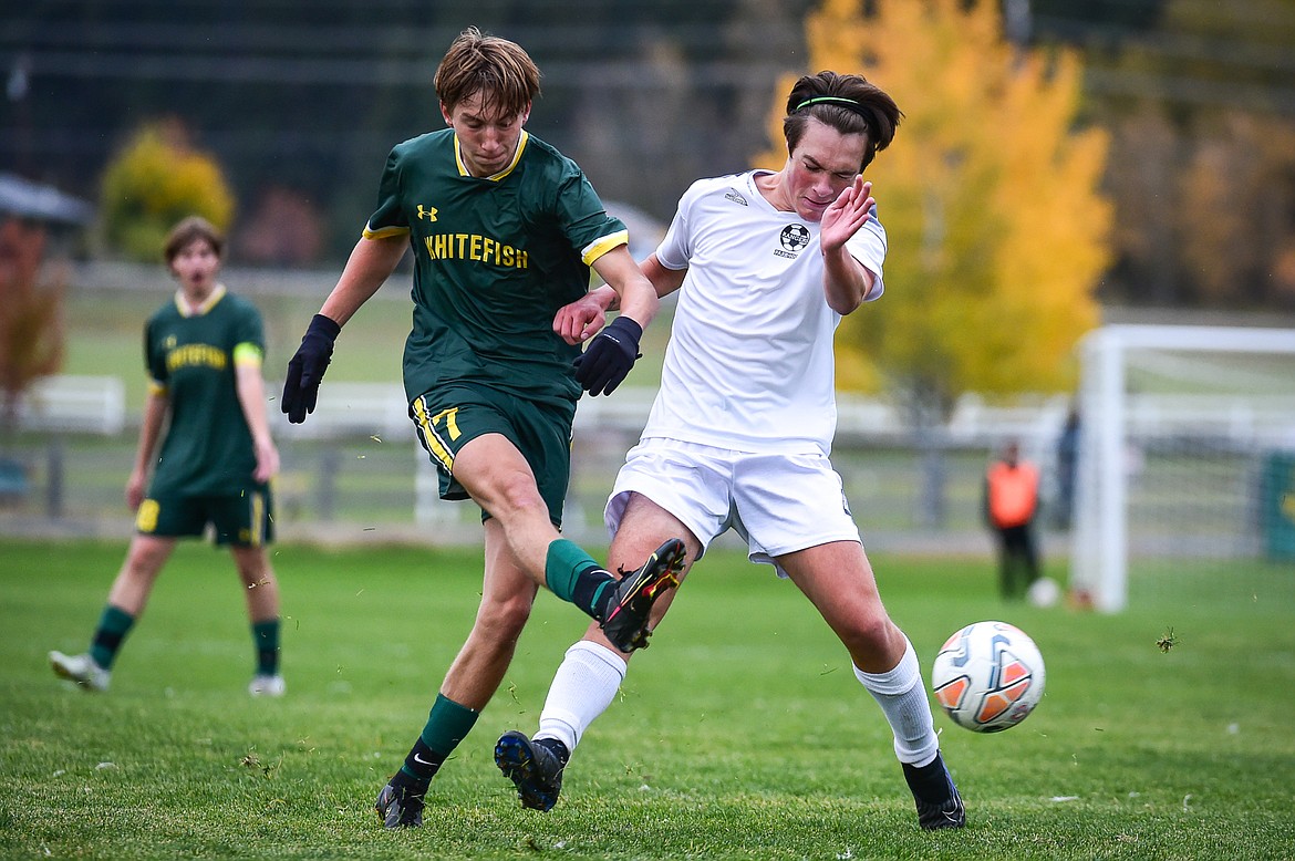 Whitefish's Elijah Adams-Griffin (7) sends a pass into the box with Livingston's Ethan Mathias (4) defending in the first half at Smith Fields on Saturday, Oct. 14. (Casey Kreider/Daily Inter Lake)