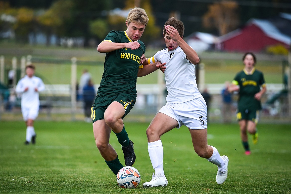 Whitefish's Preston McPherson (9) battles for possession with Livingston's Bridger Braham (5) in the first half at Smith Fields on Saturday, Oct. 14. (Casey Kreider/Daily Inter Lake)