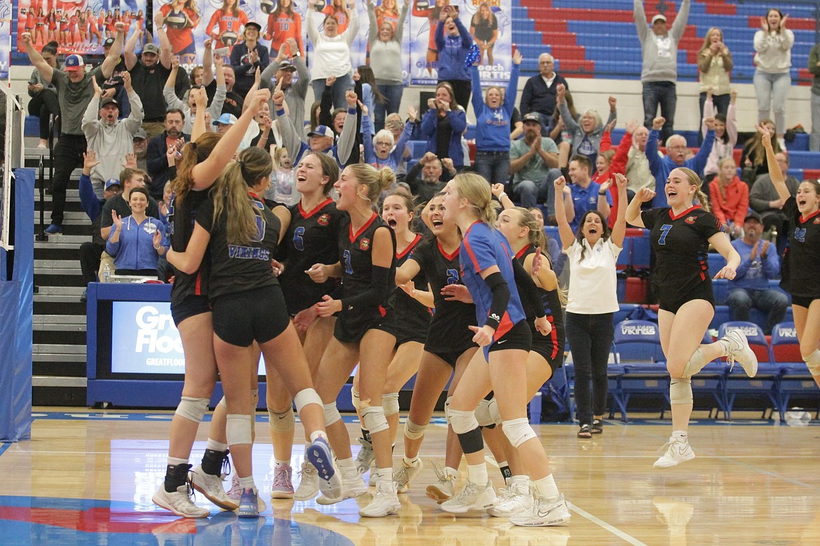 MARK NELKE/Press
Coeur d'Alene players celebrate after beating Post Falls in the championship match of the 5A Region 1 volleyball tournament Tuesday night at Viking Court.