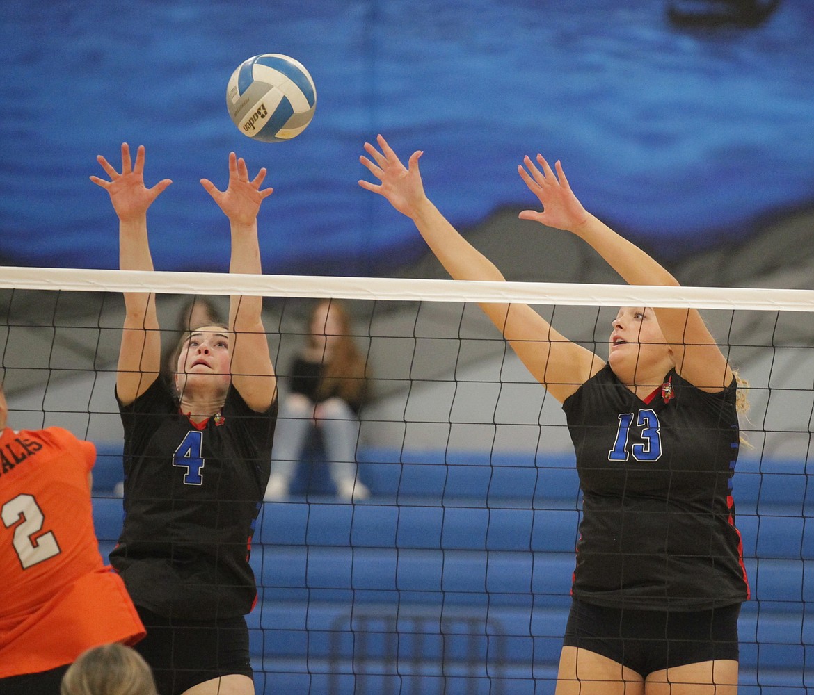 MARK NELKE/Press
Angela Maiani (4) and Olivia Naccarato (13) of Coeur d'Alene block as Vanessa Kison of Post Falls swings on Tuesday night at Viking Court in the 5A Region 1 volleyball championship match.