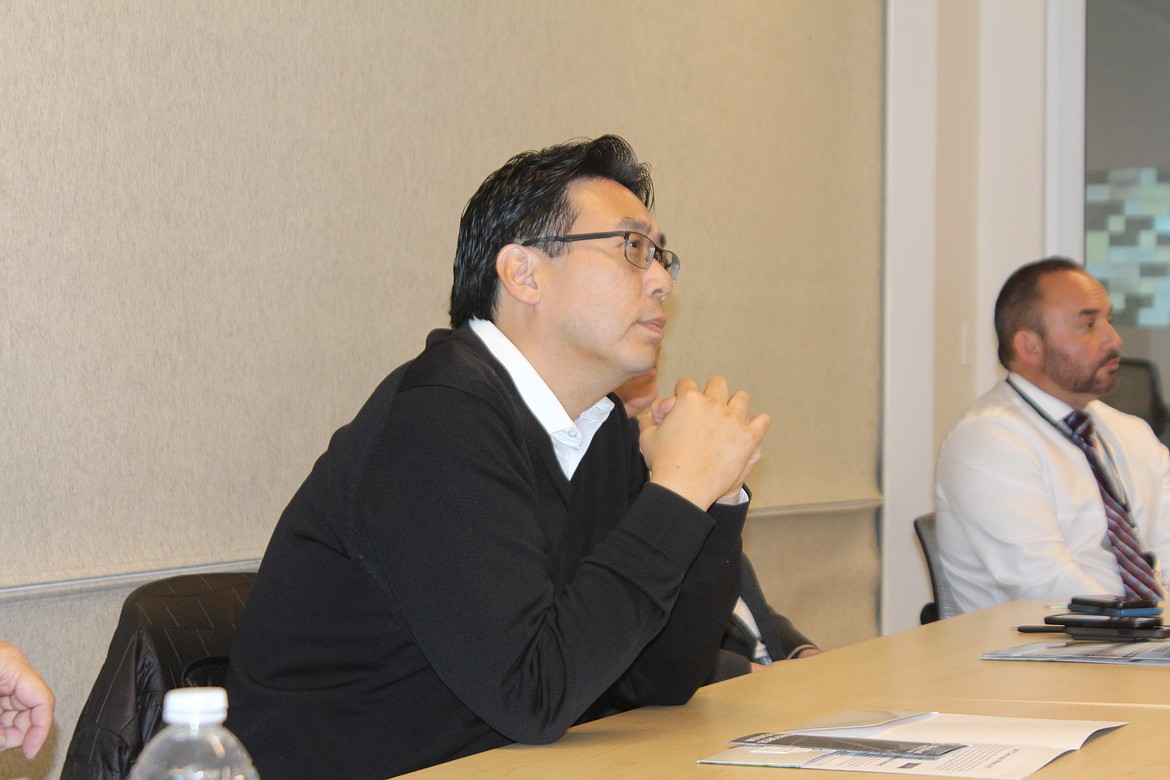 Washington Department of Commerce Director Mike Fong listens to a presentation at Big Bend Community College Monday.