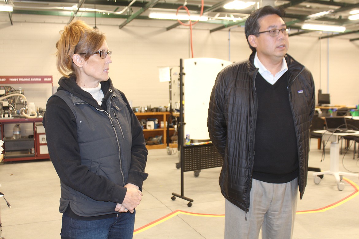 Big Bend instructor Gina Cutts, left, explains some of the programs at BBCC’s workforce education facility to Department of Commerce Director Mike Fong, right.