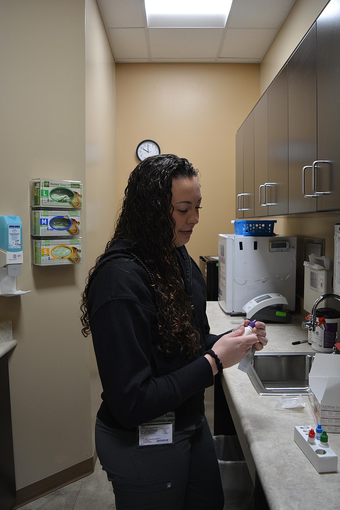 Rylee Chambers pulls out materials to process a strep test at Shoshone Medical Center's clinic in Smelterville.