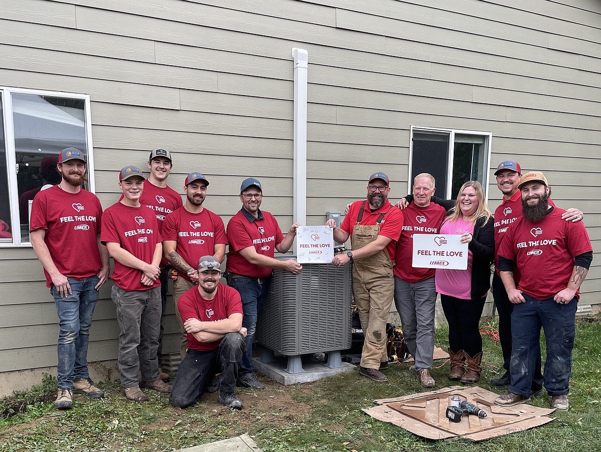 Sam Cornett, left center, is pictured with AGE Heating and Cooling employees after the Sandpoint company partnered with Lennox International’s "Feel the Love" program to offer a deserving citizen a new HVAC system, which they installed on Oct. 11.  Lennox provides the equipment, and AGE provides labor, installation, and extra materials.