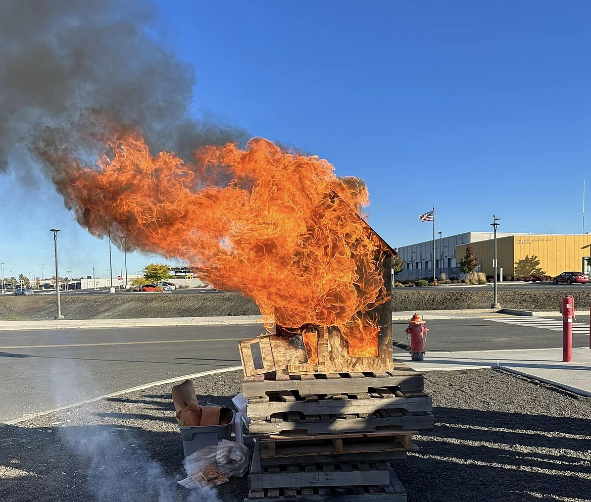 A dollhouse built by construction students at the Columbia Basin Technical Skills Center burns as part of an exercise for CBTECH fire science students.