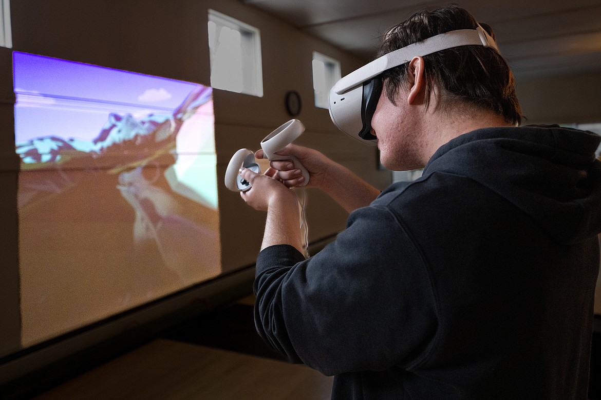 UM student Aidan Sweet uses the virtual reality hunting tool at the Spring Media Arts Expo last May. (UM photo by Ryan Brennecke)