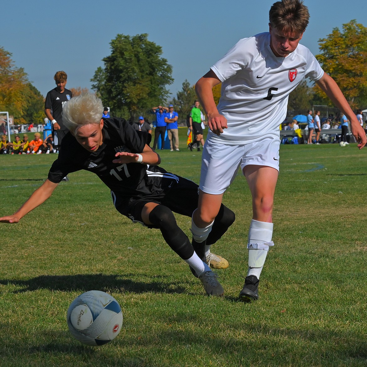 Sandpoint's Isaac Schmit (6) fights for possession of the ball against Caldwell's Walter Romero (17) on Thursday.