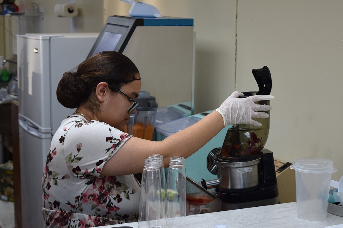 Emily Cordero, co-owner of Heavenly Fresh in Othello, prepares juices for a large delivery order.