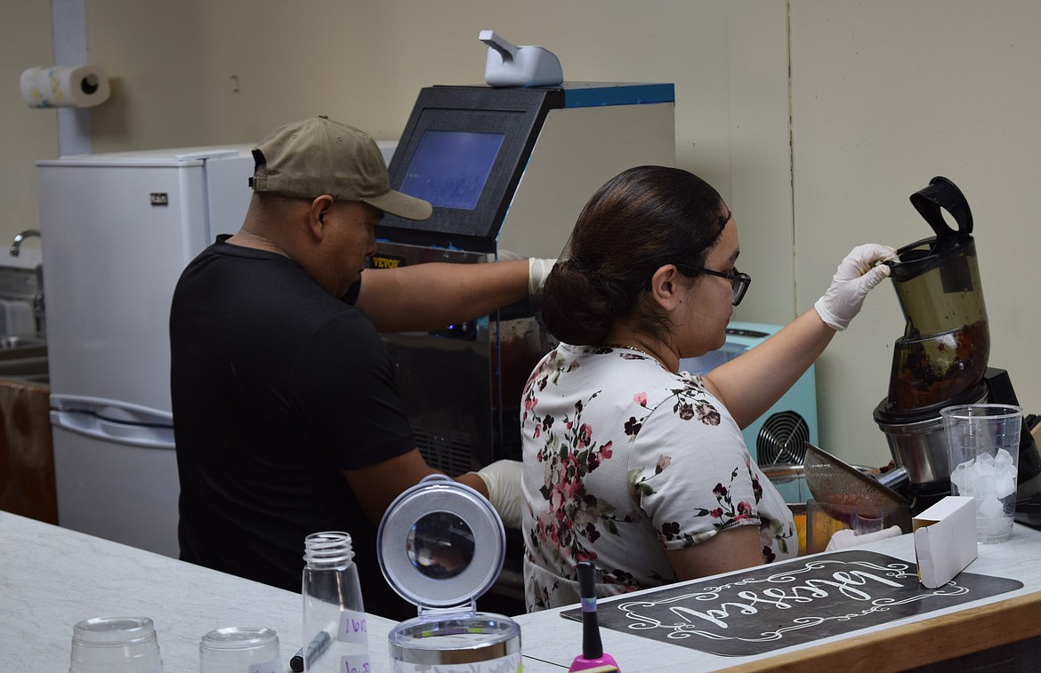 Emily Cordero and her husband, Salvador De Jesus Solano, make drinks at their juice bar, Heavenly Fresh on Hemlock Street in Othello.