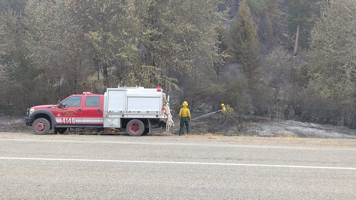 Fisher River Valley Fire Rescue fire crews work at the scene of the Gravel Pit Fire in August along U.S. 2. (Photo courtesy Fisher River Valley Fire Rescue)