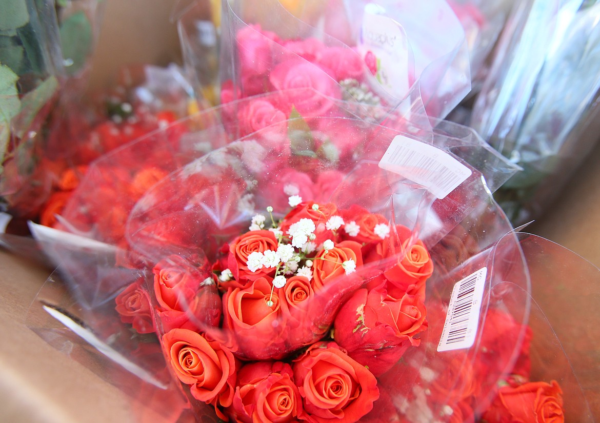 Coeur d'Alene Rotary Club members sold 1,412 dozen red, orange, yellow and pink roses during the 33rd annual Rose Sale, raising more than $50,000 that will support local projects, scholarships and causes.